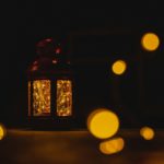 a lit lantern sitting on top of a table